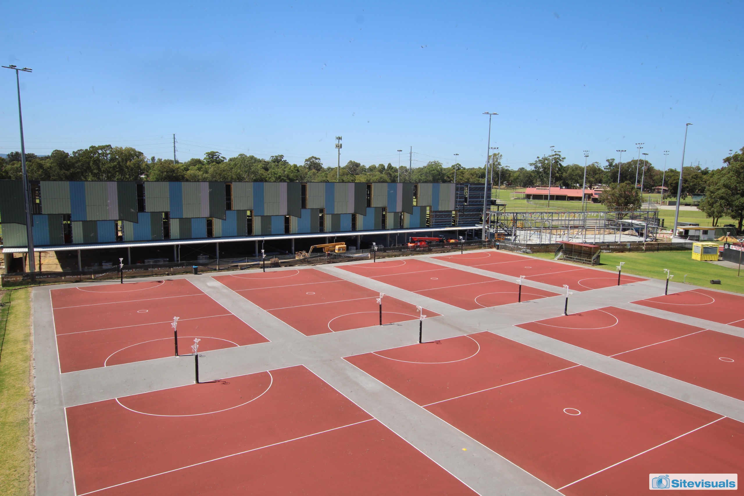 Panelling on sports courts at rear of outdoor netball courts