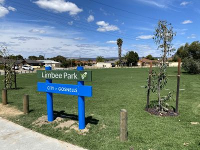 Green grass with new park sign in foreground
