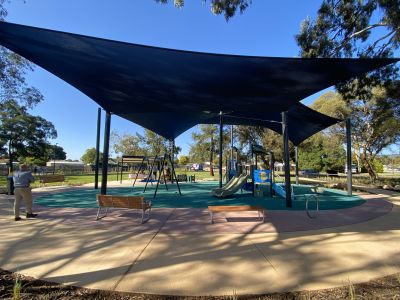Shade sails over playground with rubber softfall